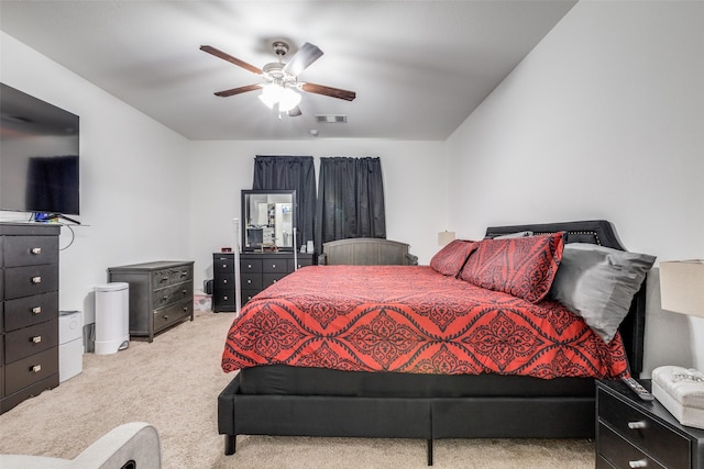 bedroom featuring ceiling fan and light carpet