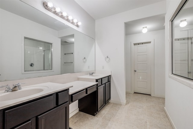 bathroom with tile patterned flooring, vanity, and walk in shower