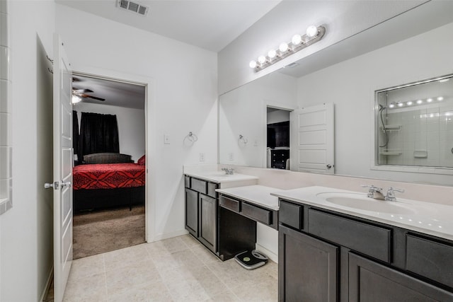 bathroom with tile patterned floors, ceiling fan, a shower, and vanity