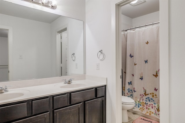 bathroom with curtained shower, tile patterned flooring, vanity, and toilet