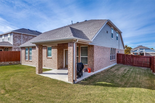 back of house featuring a yard and a patio area