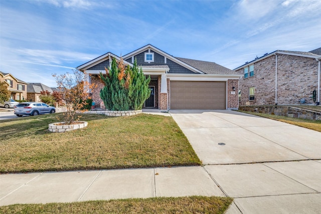 craftsman-style home featuring concrete driveway, brick siding, an attached garage, and a front lawn