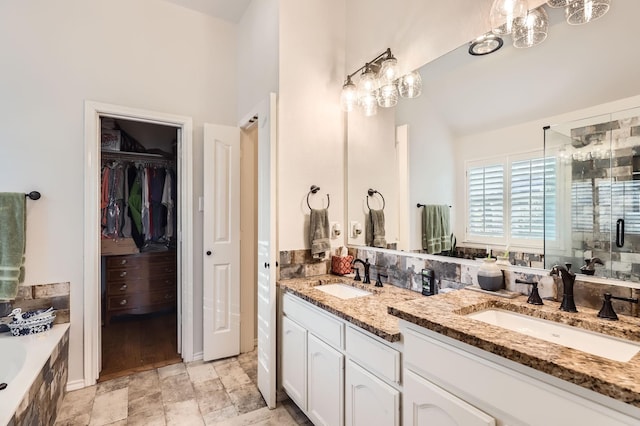 bathroom featuring plus walk in shower and vanity