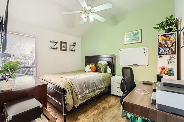 bedroom featuring ceiling fan, dark hardwood / wood-style floors, and vaulted ceiling