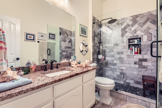 bathroom with vanity, toilet, and a shower with shower door