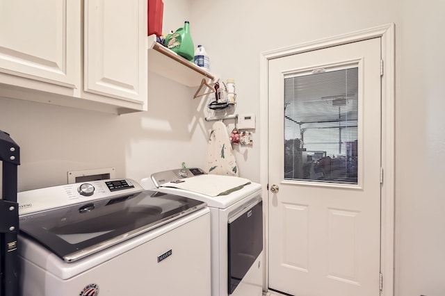 laundry room featuring cabinets and independent washer and dryer