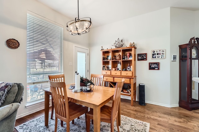 dining area featuring a notable chandelier and wood-type flooring