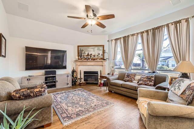 living room featuring ceiling fan and hardwood / wood-style flooring