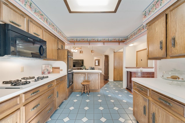 kitchen featuring decorative light fixtures and black appliances