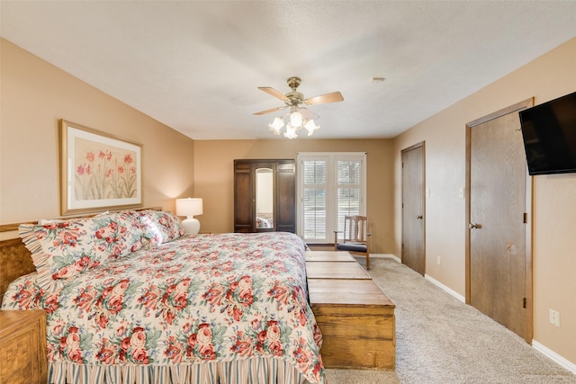 bedroom with light carpet, two closets, and ceiling fan