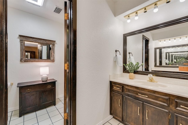 bathroom with tile patterned flooring and vanity