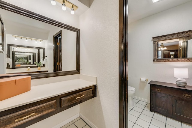 bathroom featuring tile patterned floors, vanity, ceiling fan, and toilet