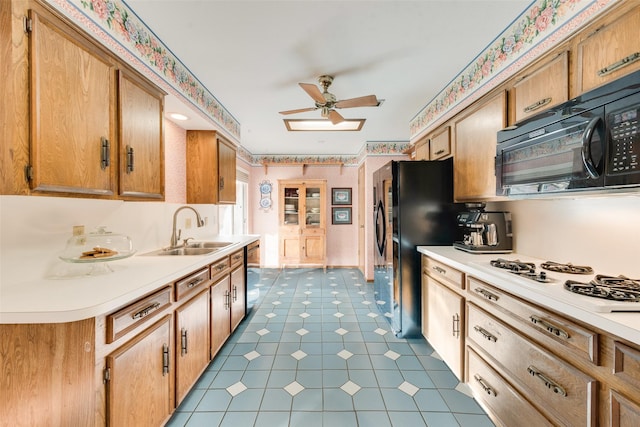 kitchen with ceiling fan, sink, and black appliances