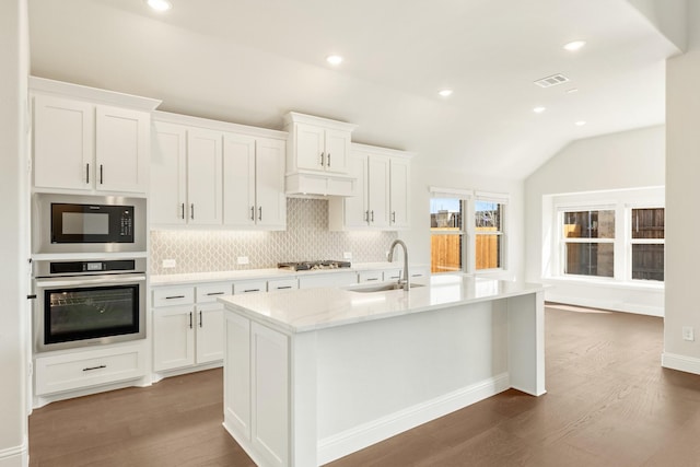 kitchen with white cabinetry, a kitchen island with sink, appliances with stainless steel finishes, and a sink