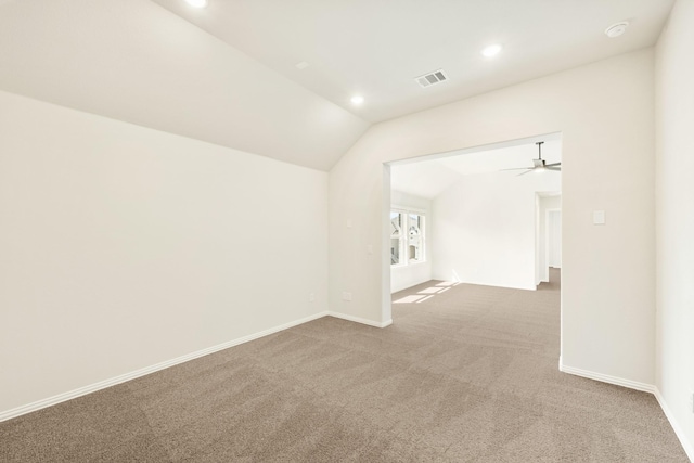 carpeted empty room with vaulted ceiling, baseboards, visible vents, and recessed lighting