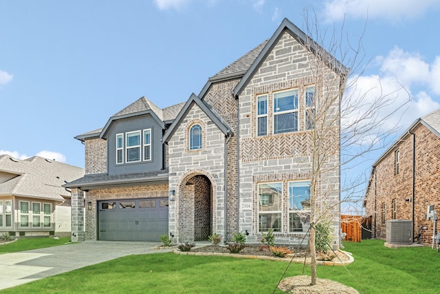 view of front of home featuring a garage, central AC unit, concrete driveway, stone siding, and a front yard