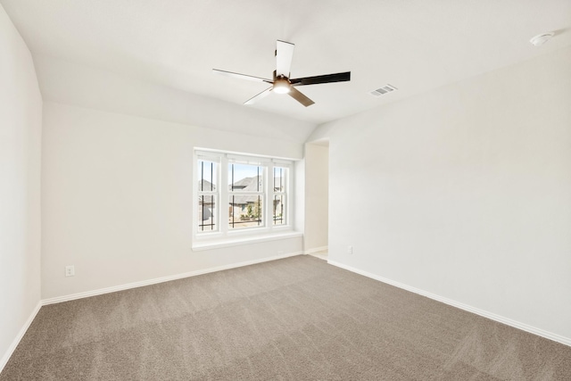 unfurnished room featuring ceiling fan, lofted ceiling, carpet floors, visible vents, and baseboards