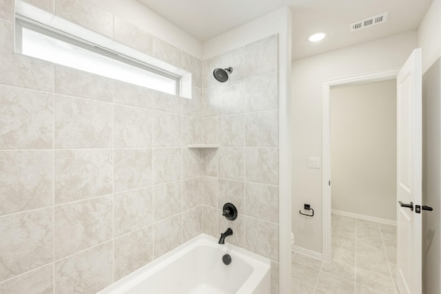 bathroom with shower / bathtub combination, toilet, visible vents, baseboards, and tile patterned floors