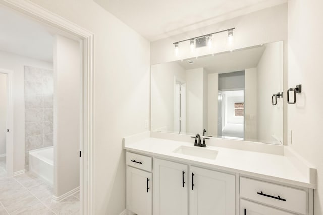 full bath with shower / washtub combination, tile patterned floors, vanity, and baseboards