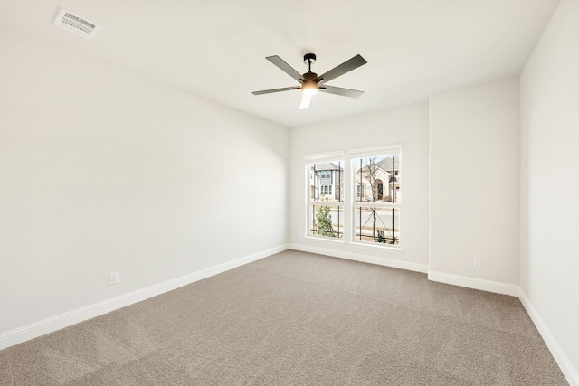 spare room featuring a ceiling fan, carpet flooring, visible vents, and baseboards