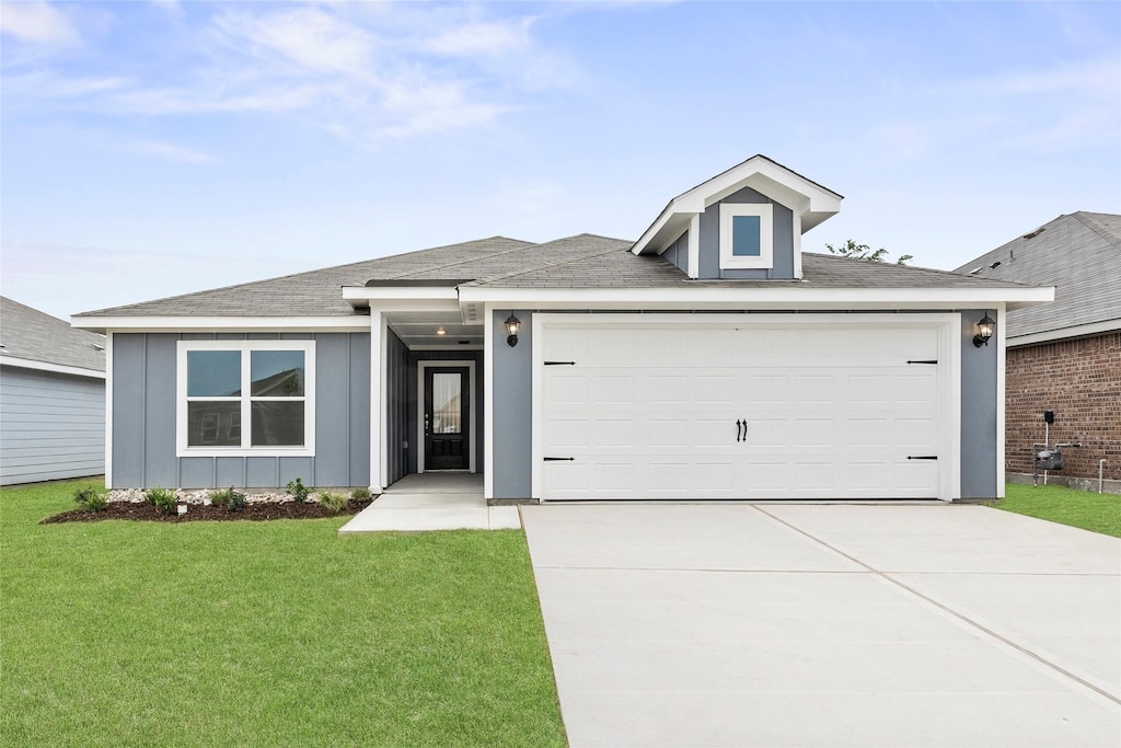 view of front facade with a front lawn and a garage