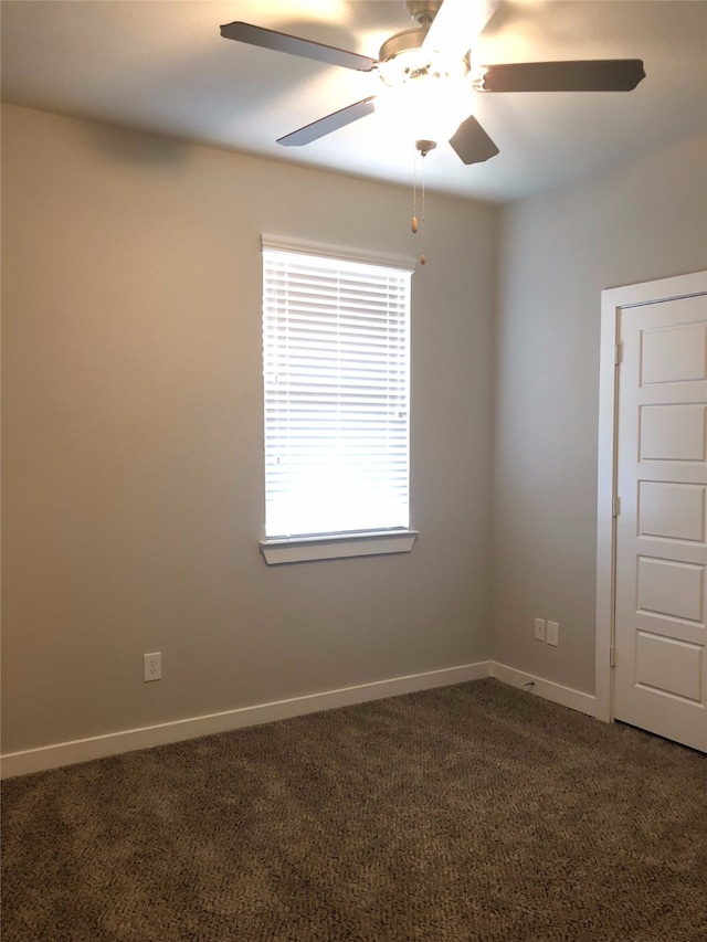 carpeted spare room with ceiling fan