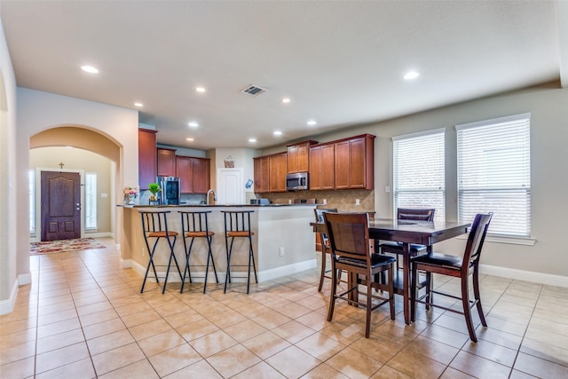 dining room featuring sink and light tile patterned floors