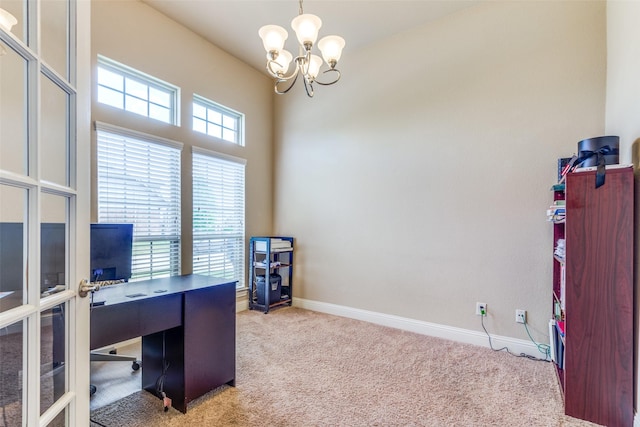 office space with a chandelier and light colored carpet