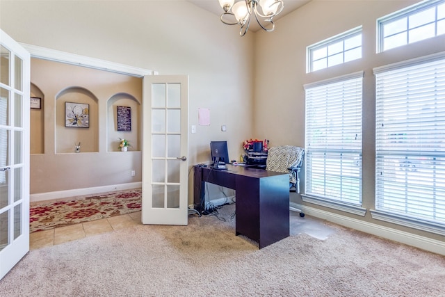 office space featuring carpet, french doors, and an inviting chandelier