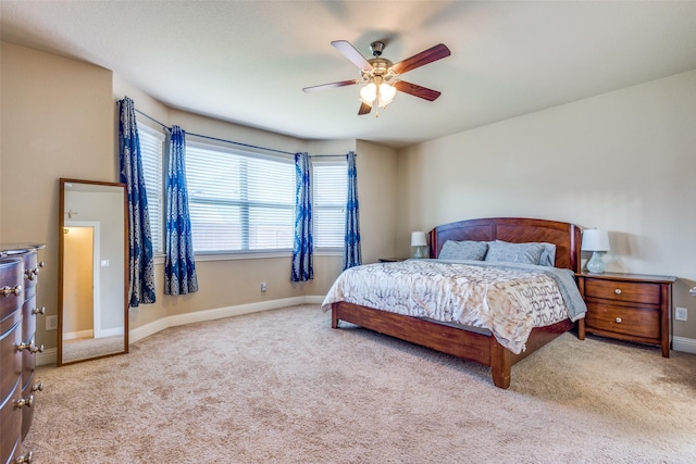 bedroom with ceiling fan and light colored carpet