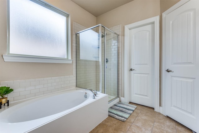 bathroom featuring tile patterned floors and separate shower and tub