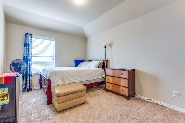 carpeted bedroom with lofted ceiling