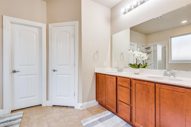 bathroom featuring tile patterned flooring, vanity, and a shower with door