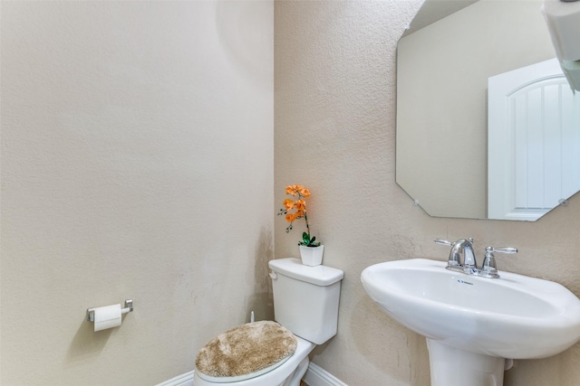 bathroom with toilet and sink