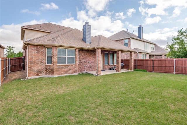 back of property with a lawn and a patio area