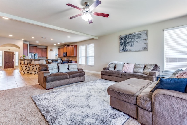 carpeted living room featuring ceiling fan