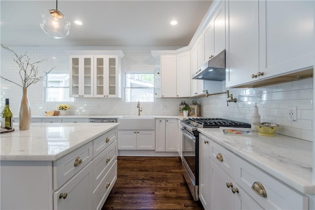 kitchen with backsplash, sink, stainless steel gas stove, dark hardwood / wood-style flooring, and white cabinetry