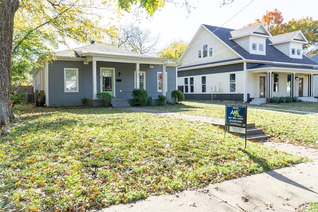 view of front of home with a front yard and central air condition unit