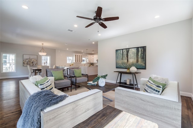 living room featuring dark hardwood / wood-style floors and ceiling fan