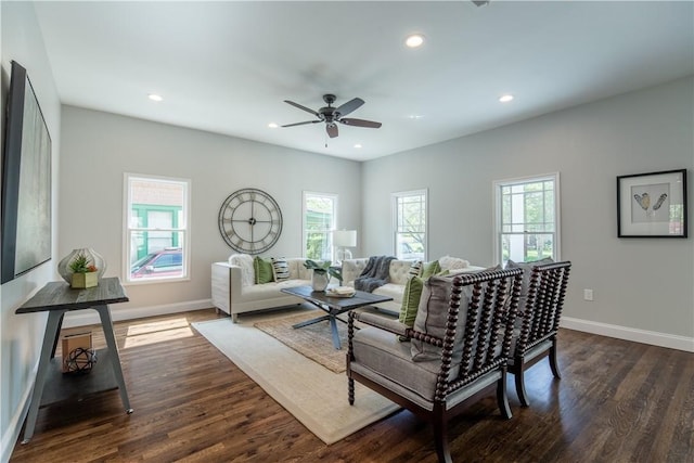 living room with ceiling fan and dark hardwood / wood-style floors