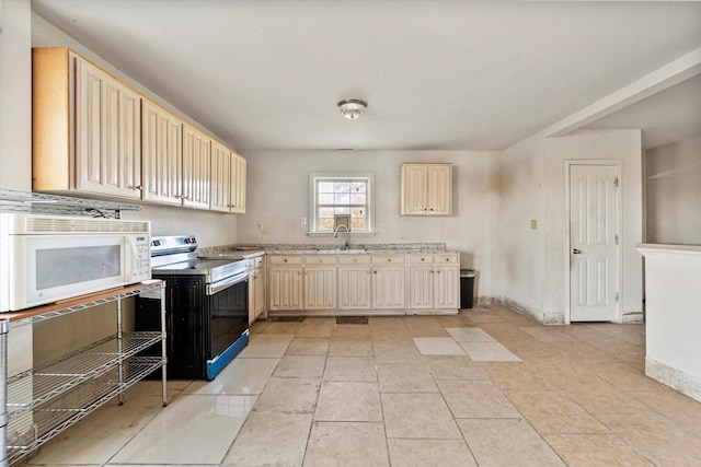 kitchen featuring electric range, light tile patterned floors, and sink