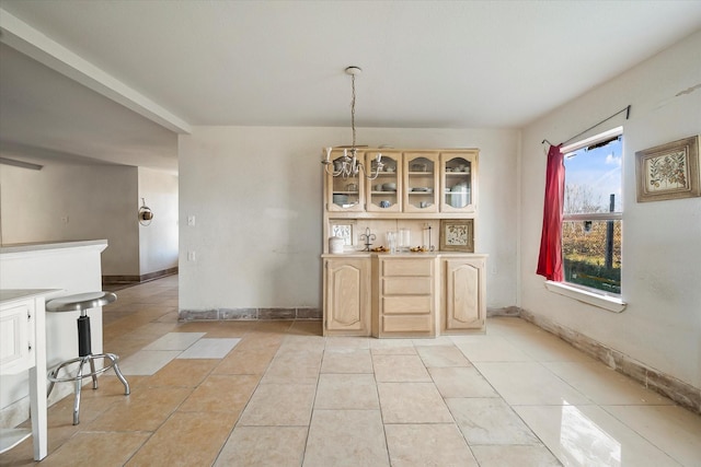 bar featuring pendant lighting, light tile patterned floors, and light brown cabinetry