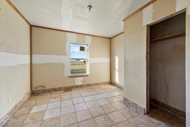 unfurnished bedroom featuring a closet and crown molding