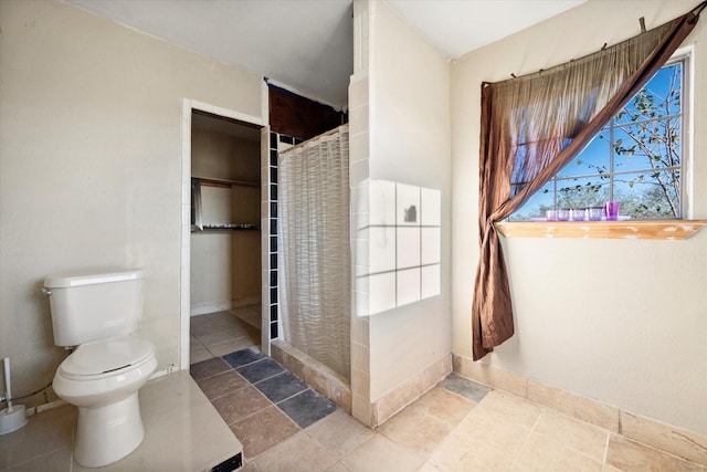 bathroom with toilet and walk in shower