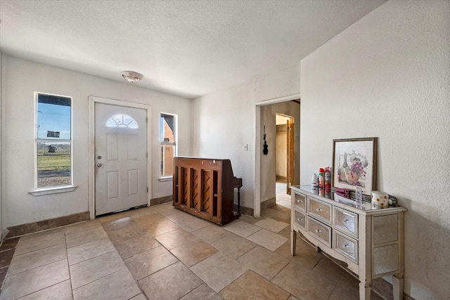 foyer entrance with a textured ceiling