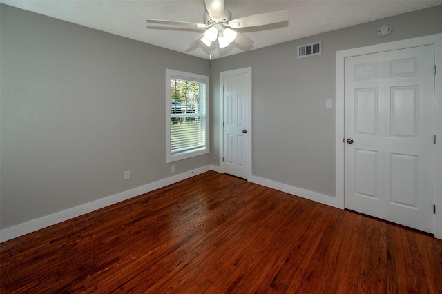 unfurnished bedroom with a textured ceiling, hardwood / wood-style flooring, and ceiling fan