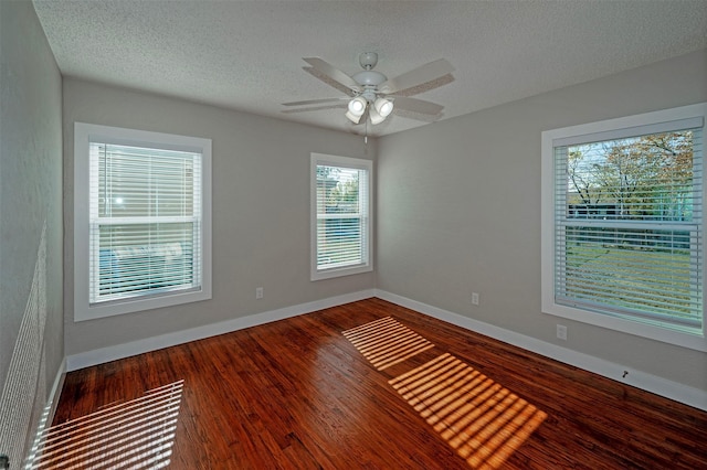 unfurnished room with wood-type flooring, a textured ceiling, and ceiling fan