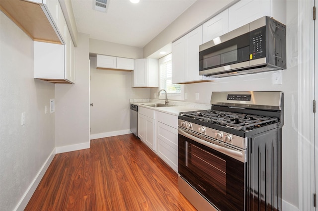 kitchen with white cabinetry, sink, dark wood-type flooring, and appliances with stainless steel finishes