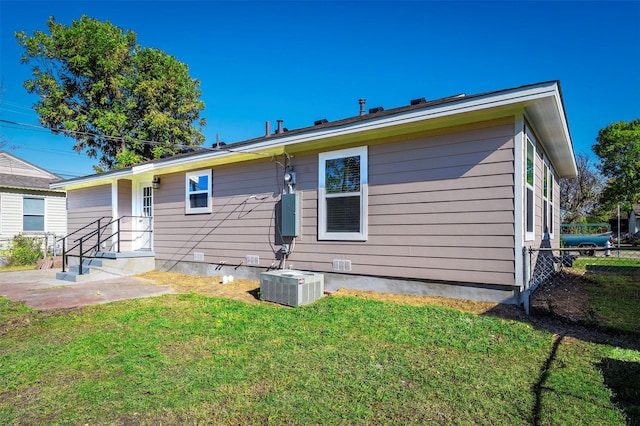 rear view of house featuring a yard, a patio area, and central air condition unit