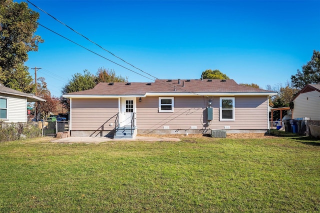 rear view of house featuring a lawn, cooling unit, and a patio